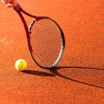 tennis raquet on clay court